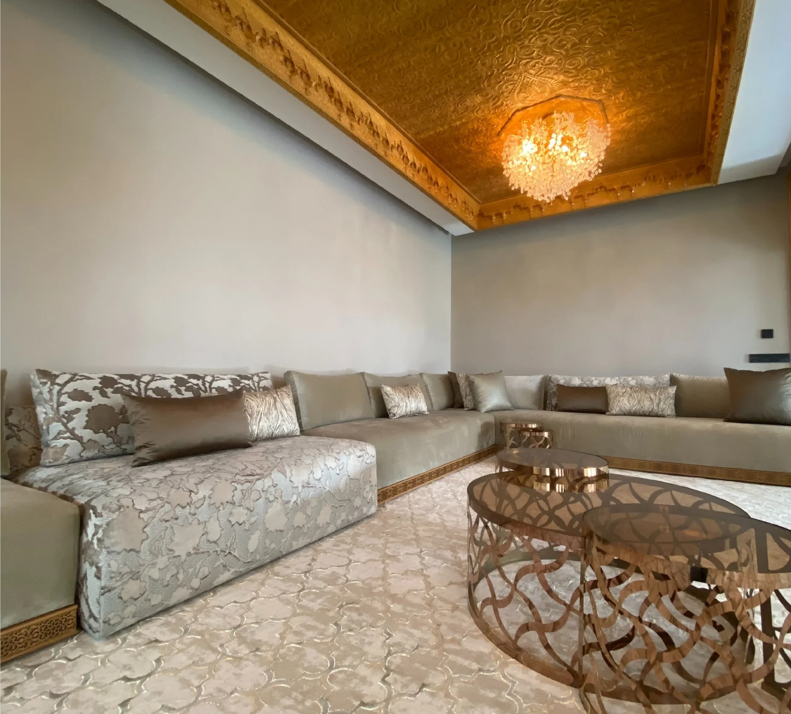 Traditional majlis lounge with U-shaped sofa and gold ceiling