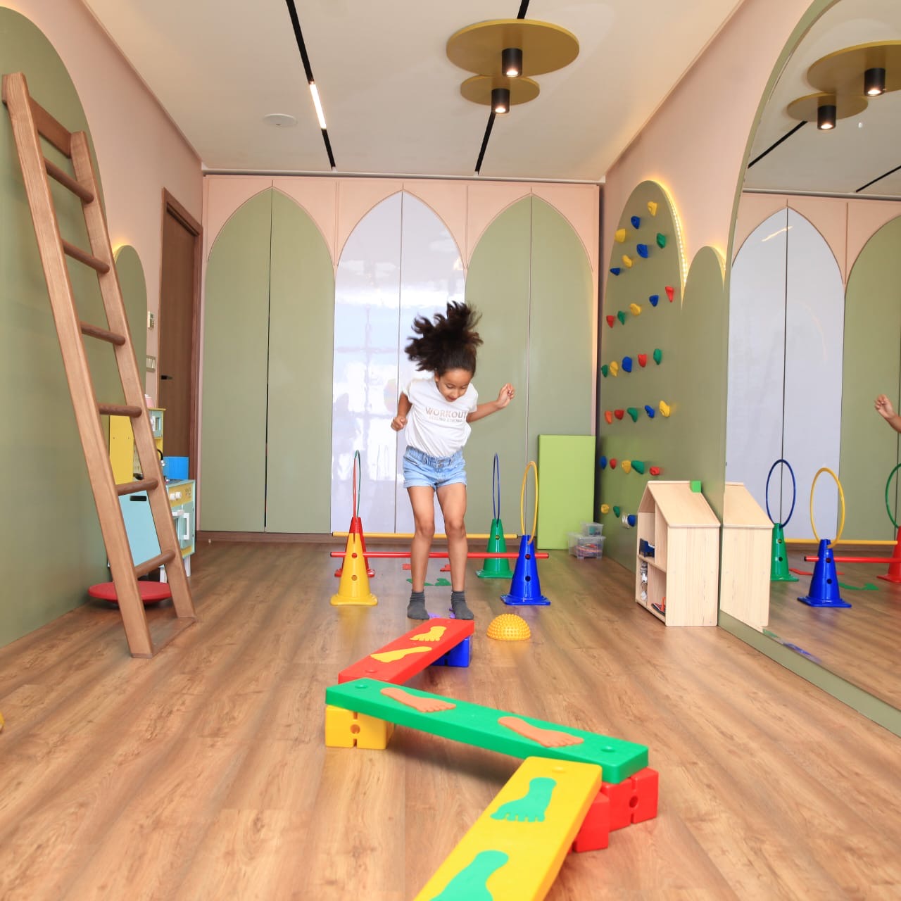 Full room overview with arched doors and open play space